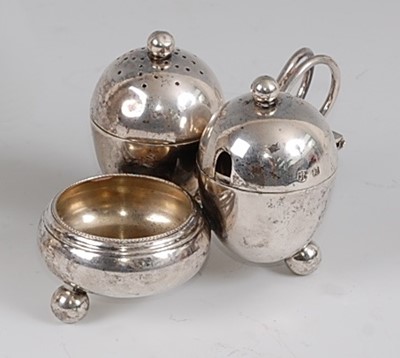 Lot 104 - An Arts & Crafts silver three-piece cruet set...