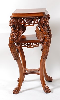 Lot 1545 - A contemporary carved walnut three-tier...