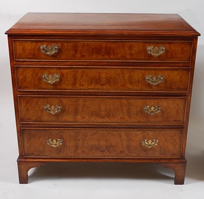 Lot 1555 - A walnut and figured walnut four-drawer...