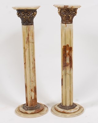 Lot 1570 - A pair of onyx and gilt metal mounted fluted...