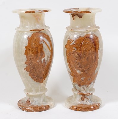 Lot 1571 - A pair of onyx pedestal urns, of slender...