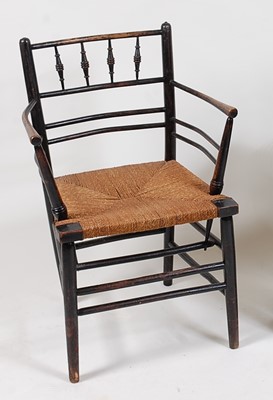 Lot 292 - An Arts & Crafts ebonised Sussex chair,...