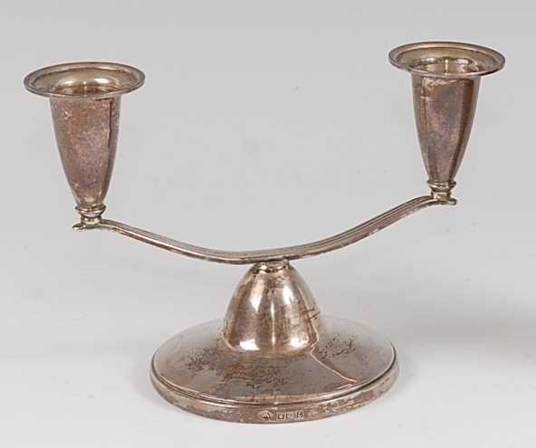 Lot 105 - A 1960s silver squat twin branch candle-holder,...