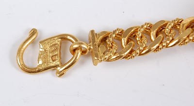 Lot 1212 - A Middle Eastern yellow metal flat and rope...