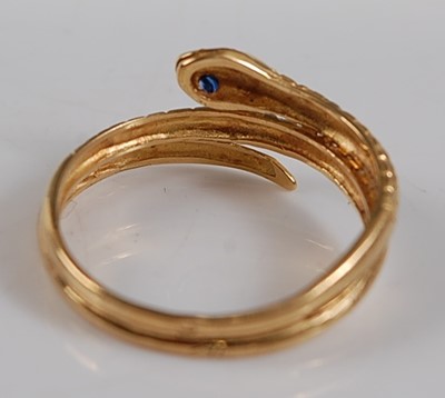 Lot 2650 - A yellow metal snake ring, the head set with...