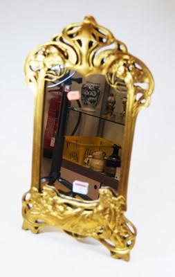 Lot 9 - An Art Nouveau style gilt framed easel mirror,...