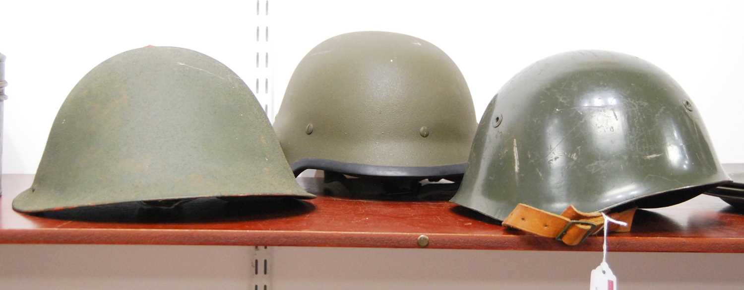 Lot 13 - A post-WWII green painted turtle helmet;...