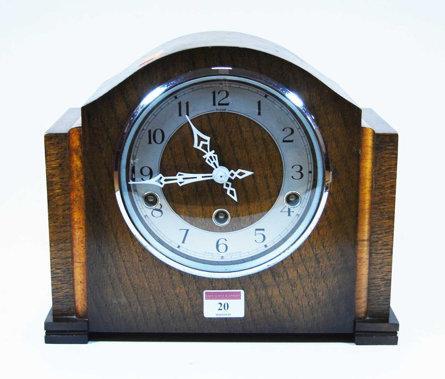 Lot 20 - A 1930s oak cased mantel clock, the chapter...