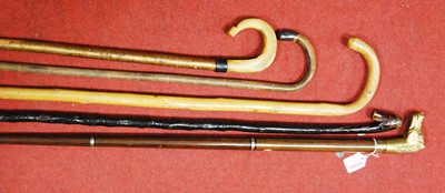 Lot 32 - A 20th century walking stick, the brass handle...