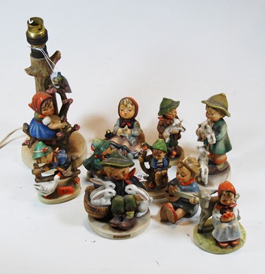 Lot 245 - A collection of Hummel figures, to include...