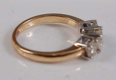 Lot 2588 - A yellow metal diamond three-stone ring,...