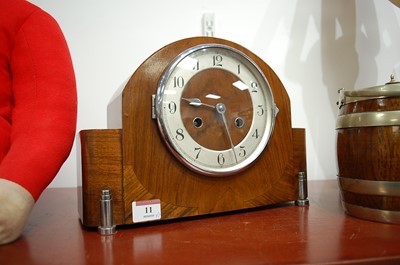 Lot 11 - A 1930s walnut cased mantel clock the silvered...