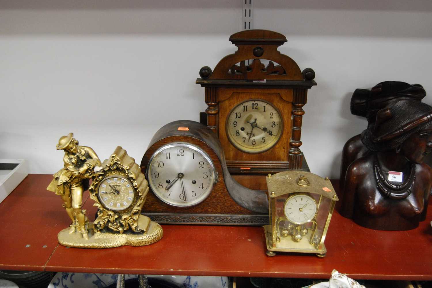 Lot 55 - A 1930s oak cased mantel clock, the silvered...