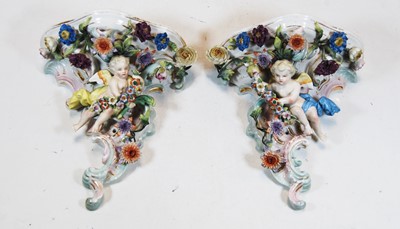 Lot 152 - A pair of German floral encrusted porcelain...