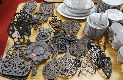 Lot 156 - A collection of continental cast iron trivets,...