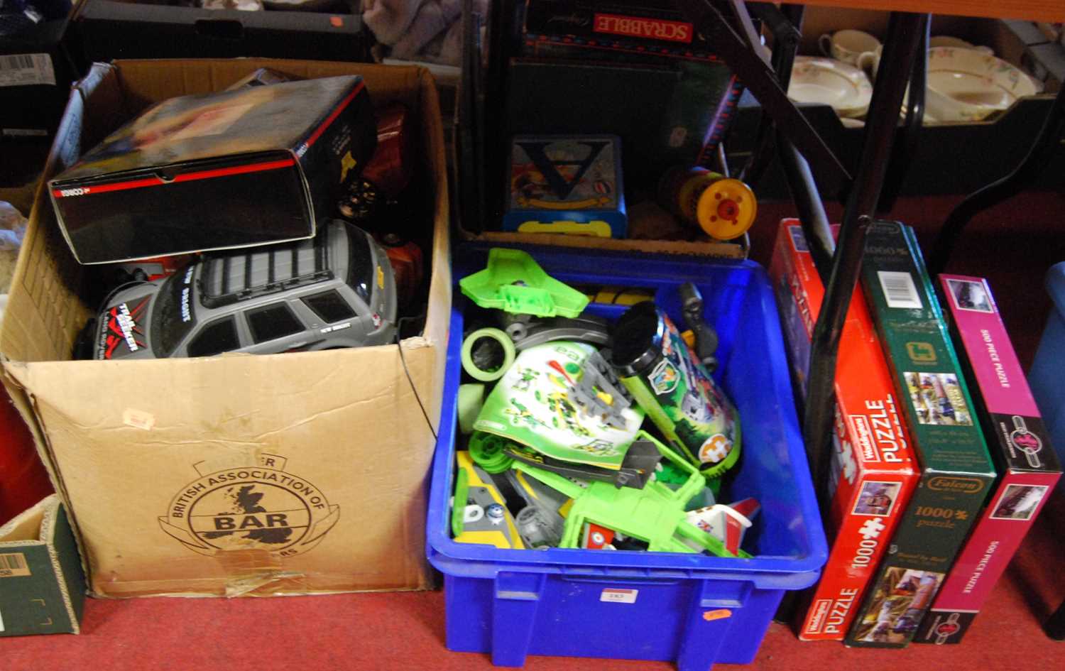 Lot 183 - Three boxes of various toys and games to...