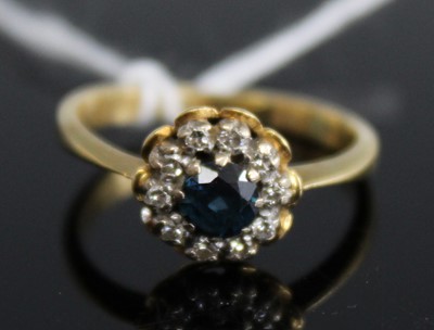 Lot 382 - An 18ct gold sapphire and diamond flowerhead...