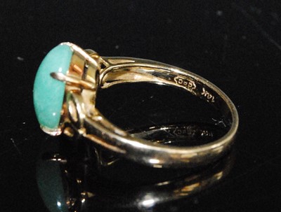 Lot 2552 - A yellow metal jadeite dress ring, featuring a...
