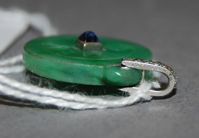 Lot 2563 - An Art Deco jade disc pendant, incised to...