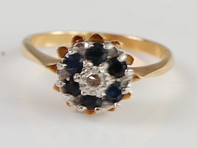 Lot 2676 - An 18ct gold, blue and white sapphire flower...
