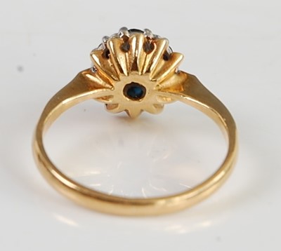 Lot 2676 - An 18ct gold, blue and white sapphire flower...