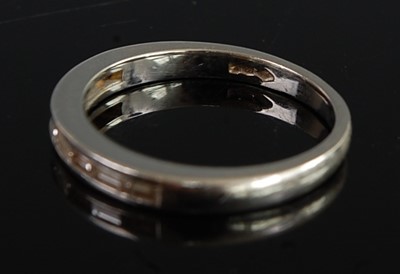Lot 2692 - A platinum diamond half eternity ring,...