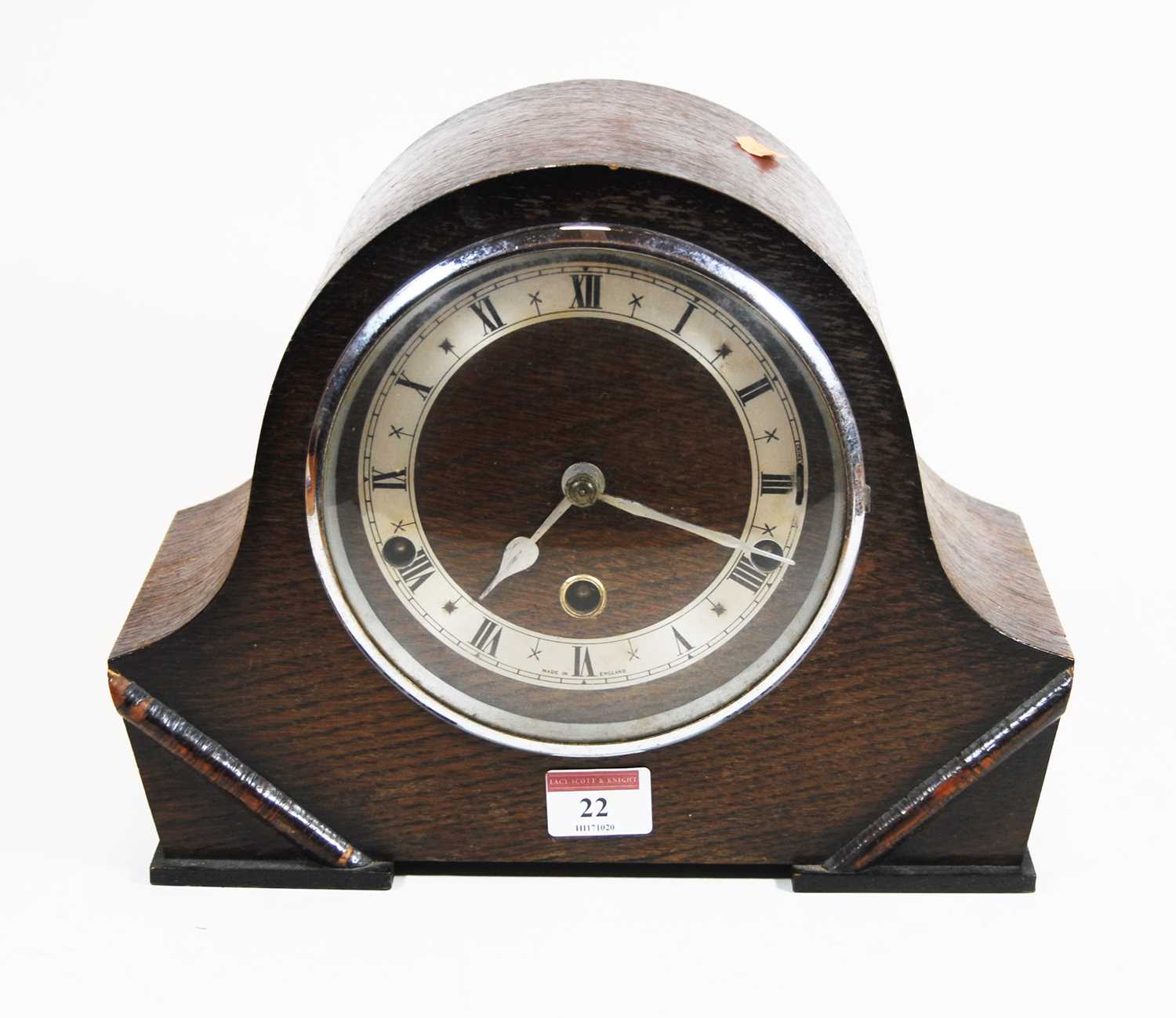 Lot 22 - A 1930s oak cased mantel clock, the silvered...