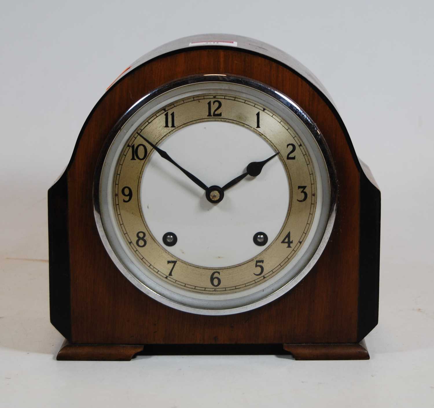 Lot 60 - A 1930s walnut cased mantel clock, the...