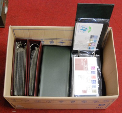 Lot 93 - A box containing various albums of first day...