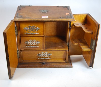 Lot 127 - An early 20th century oak smoker's cabinet,...