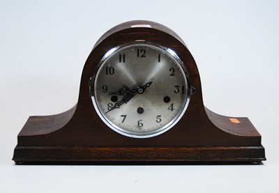 Lot 152 - A 1930s oak cased Nelsons hat mantel clock,...