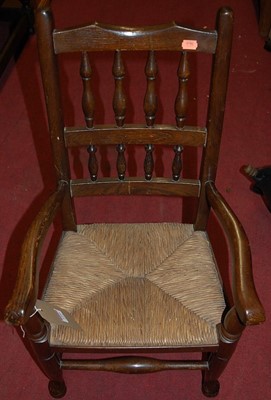 Lot 1252 - An early 20th century oak and rush seat...