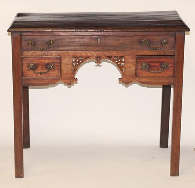 Lot 1132 - A George III mahogany lowboy, the top having a...