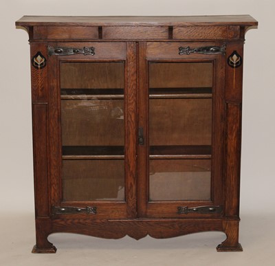 Lot 332 - An Arts & Crafts oak double door glazed...