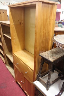Lot 1240 - A modern pine bookshelf with lower cupboard...