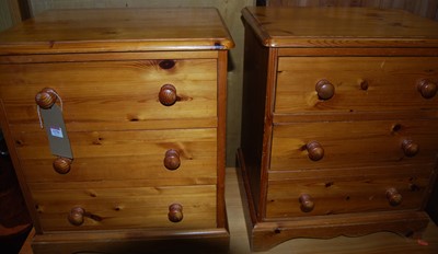 Lot 1270 - A pair of pine three drawer bedside chests,...