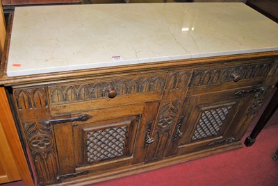 Lot 1244 - A joined oak sideboard, with white marble top,...