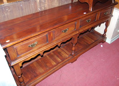 Lot 1438 - A joined hardwood long dresser base, with...