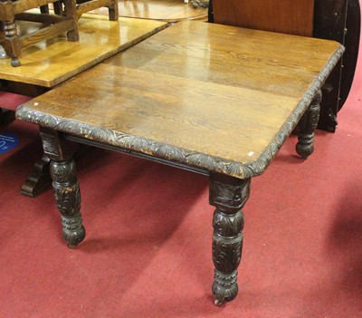 Lot 1328 - A circa 1900 carved oak extending dining table,...