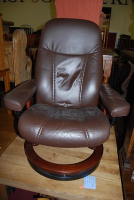 Lot 1283 - A Stressless brown leather upholstered swivel...