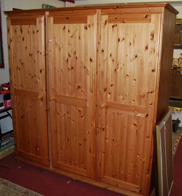 Lot 1142 - A modern pine three door wardrobe, w.193cm