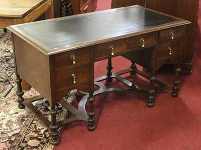 Lot 1416 - An early 20th century oak kneehole desk, 136cm