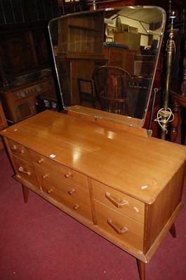 Lot 1358 - A 1970s walnut mirrorback dressing table, w.125cm