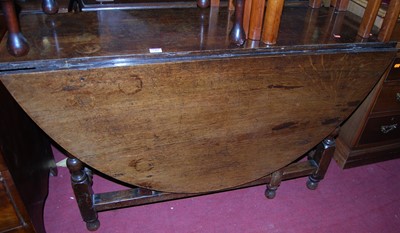 Lot 1465 - An 18th century style oak gateleg dining table,...