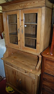 Lot 1349 - A pine dresser, with twin glazed upper doors,...