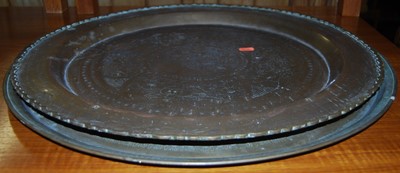 Lot 1287 - Two Indian brass trays, largest 58cm dia.