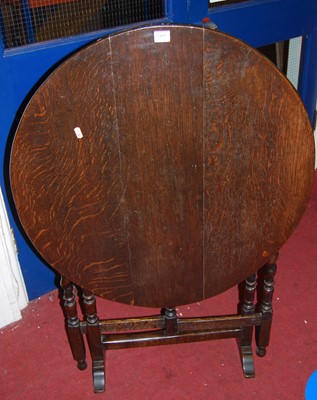 Lot 1445 - An early 20th century oval tilt-top folding...