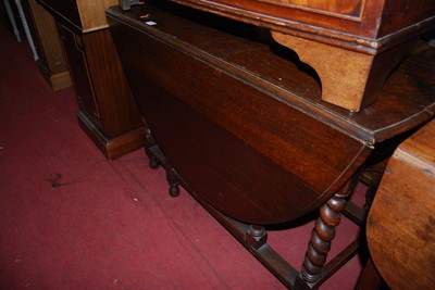 Lot 1448 - A 1930s oak oval drop-leaf dining table, w.102cm