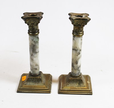 Lot 10 - A pair of brass and veined marble candlesticks,...