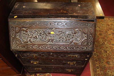 Lot 1346 - A Victorian carved oak bureau, decorated with...